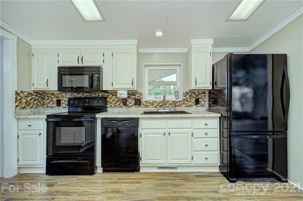 7918 Morgan Mill Road Monroe, NC 28110 - Photo 13 of 37 a kitchen with a sink stove and refrigerator