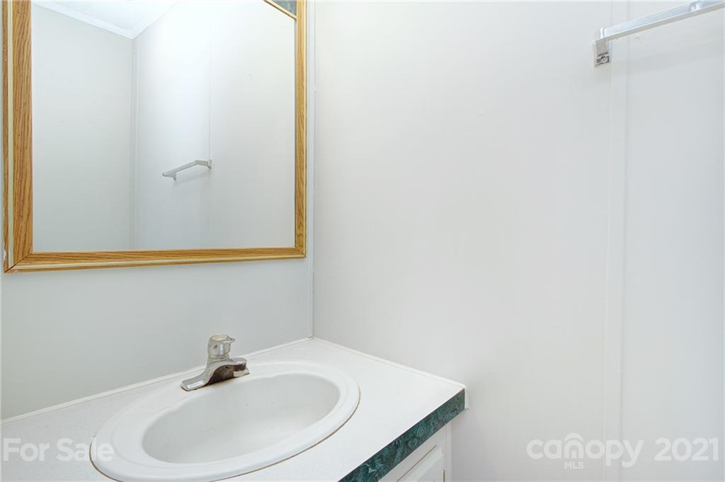 7918 Morgan Mill Road Monroe, NC 28110 - Photo 20 of 37 a bathroom with a sink and a mirror