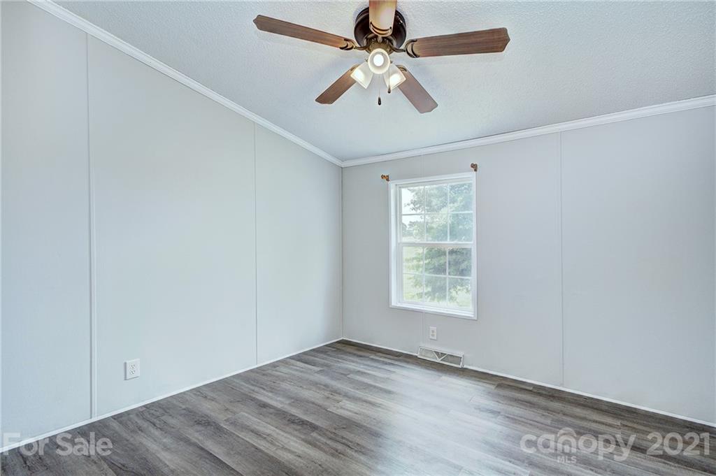 7918 Morgan Mill Road Monroe, NC 28110 - Photo 24 of 37 wooden floor in an empty room with a window