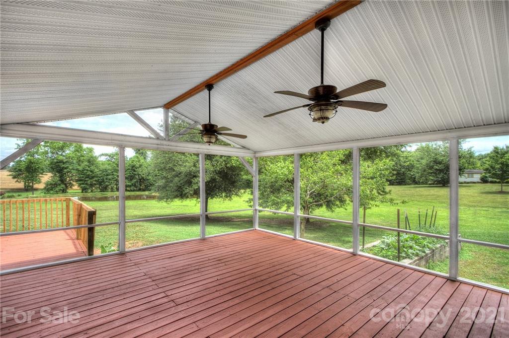 7918 Morgan Mill Road Monroe, NC 28110 - Photo 26 of 37 a view of a deck with a big yard