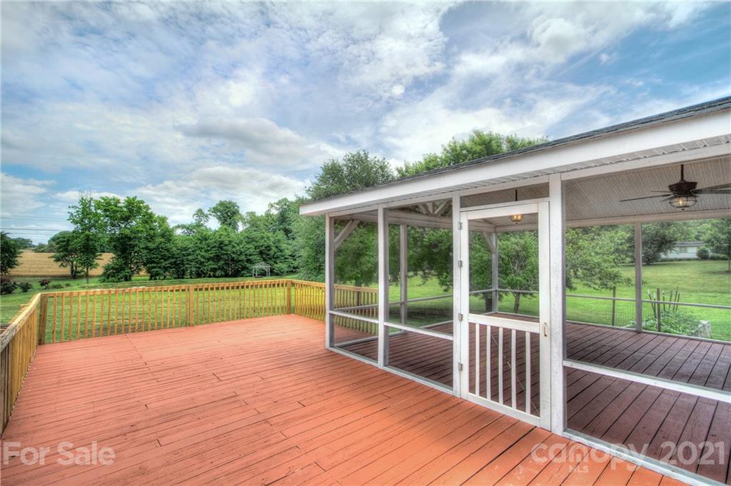 7918 Morgan Mill Road Monroe, NC 28110 - Photo 27 of 37 a view of a backyard with a deck and a lake view