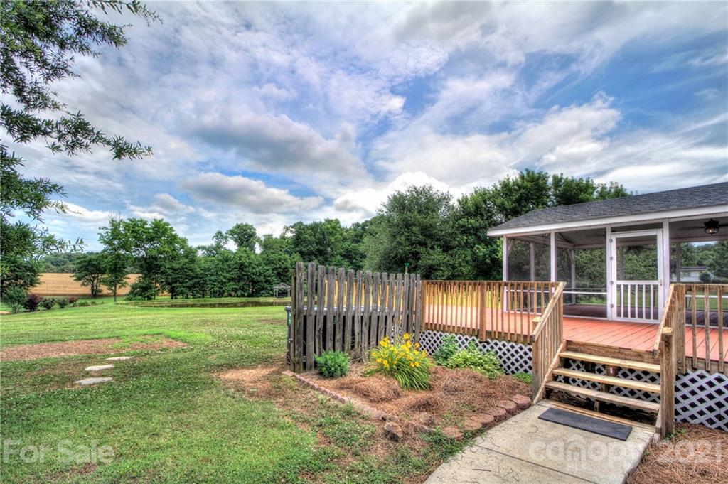 7918 Morgan Mill Road Monroe, NC 28110 - Photo 28 of 37 a backyard of a house with lots of green space table and chairs