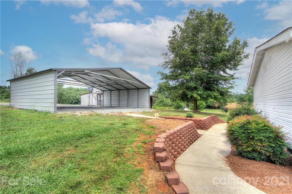 7918 Morgan Mill Road Monroe, NC 28110 - Photo 29 of 37 a view of a house with a yard