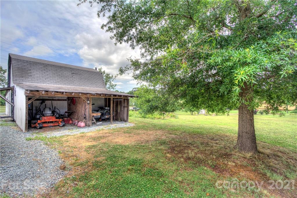7918 Morgan Mill Road Monroe, NC 28110 - Photo 31 of 37 a view of a house with backyard porch and sitting area