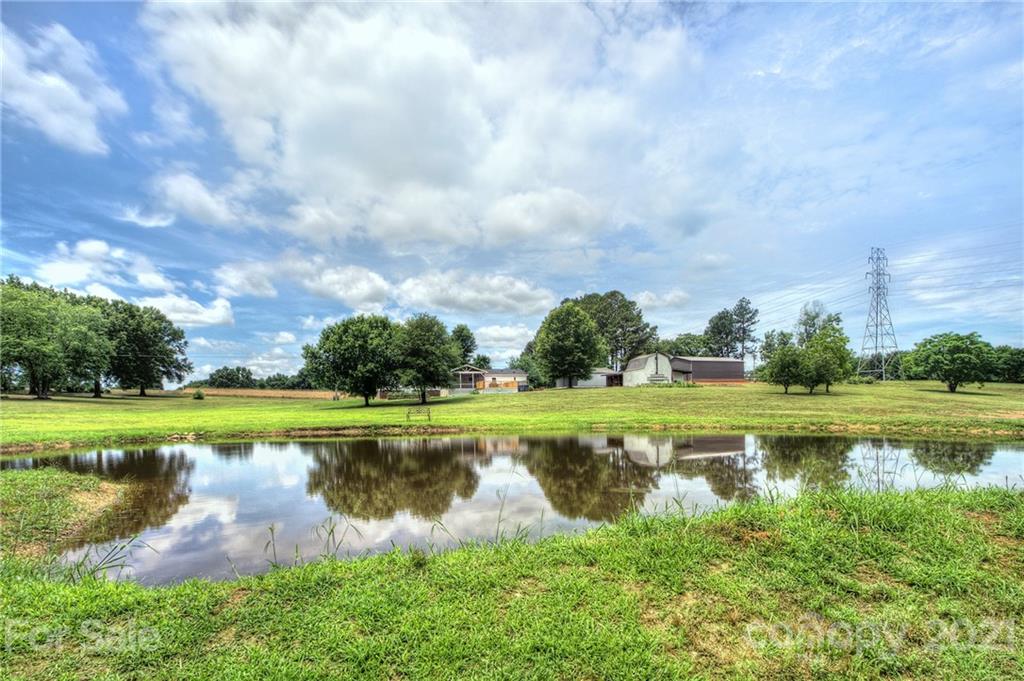7918 Morgan Mill Road Monroe, NC 28110 - Photo 35 of 37 a view of a lake with a big yard
