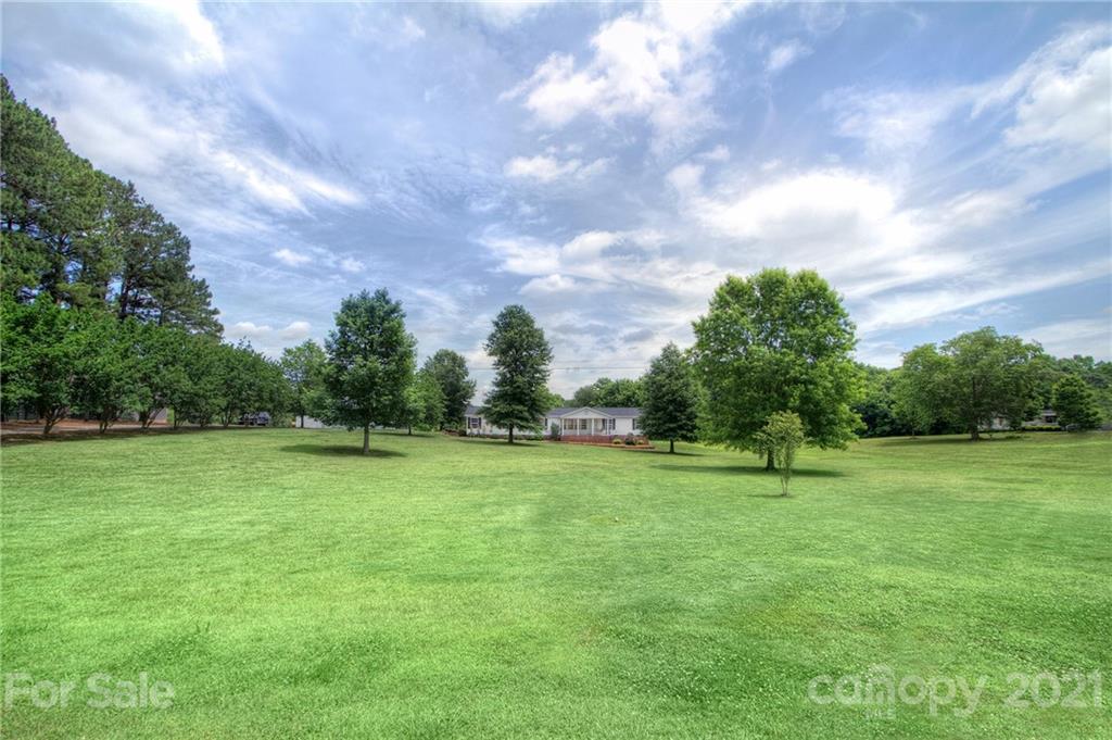 7918 Morgan Mill Road Monroe, NC 28110 - Photo 5 of 37 a view of outdoor space with deck and trees