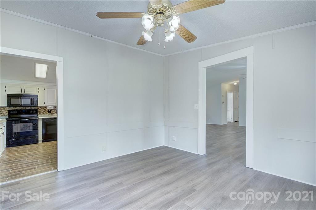 7918 Morgan Mill Road Monroe, NC 28110 - Photo 10 of 37 wooden floor in an empty room with a window