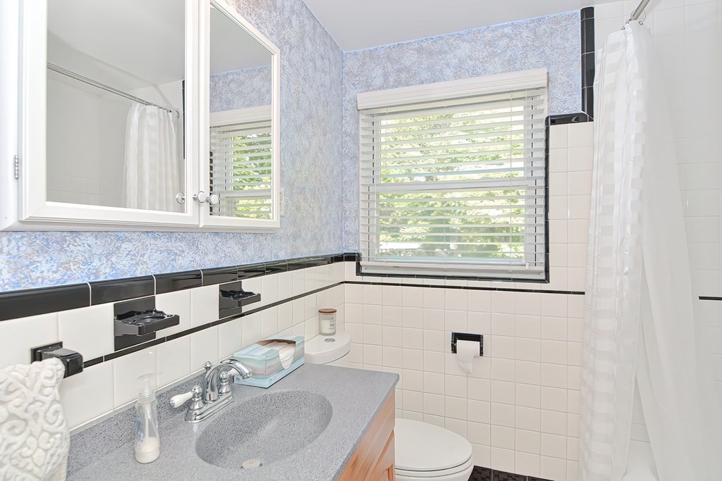 51 Albert Road Newton, MA 02466 - Photo 19 of 40 a bathroom with a granite countertop sink and a large mirror