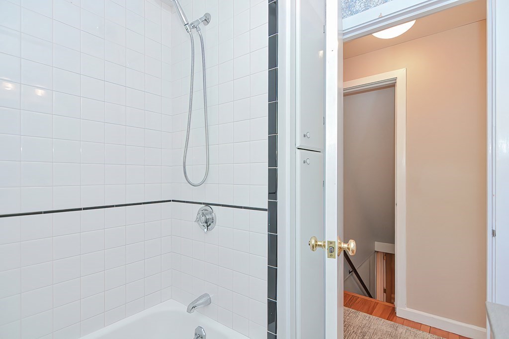 51 Albert Road Newton, MA 02466 - Photo 20 of 40 a bathroom with a glass shower door