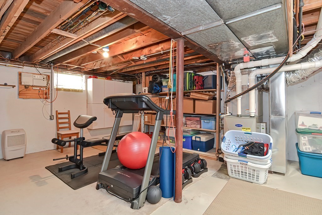 51 Albert Road Newton, MA 02466 - Photo 29 of 40 a room with wooden furniture and musical instruments