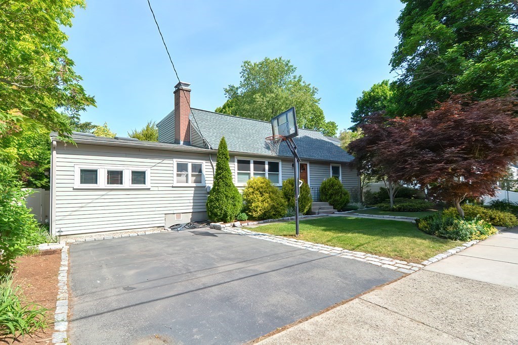 51 Albert Road Newton, MA 02466 - Photo 38 of 40 a front view of a house with a yard and potted plants