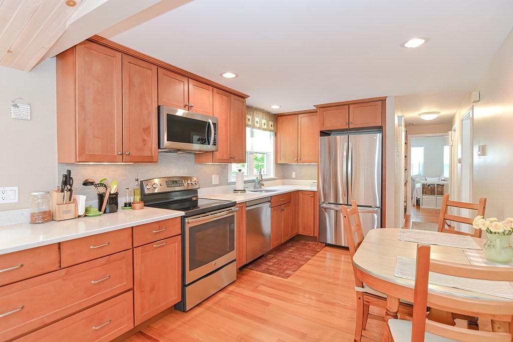 51 Albert Road Newton, MA 02466 - Photo 7 of 40 a kitchen with stainless steel appliances granite countertop a stove a sink dishwasher and a refrigerator with wooden floor