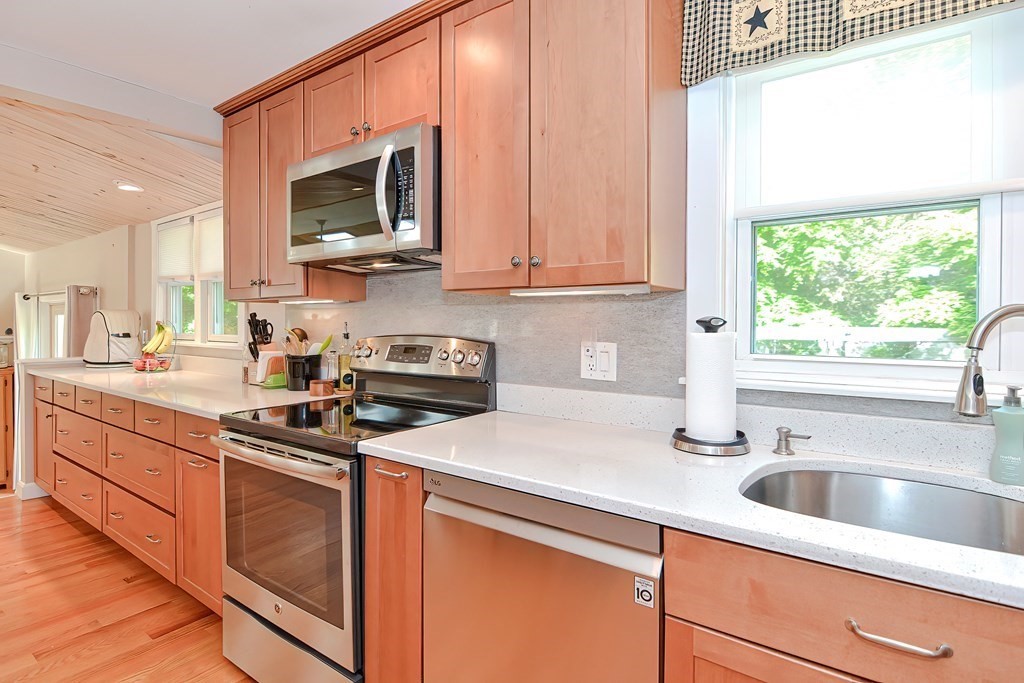 51 Albert Road Newton, MA 02466 - Photo 10 of 40 a kitchen with stainless steel appliances a sink a stove and microwave