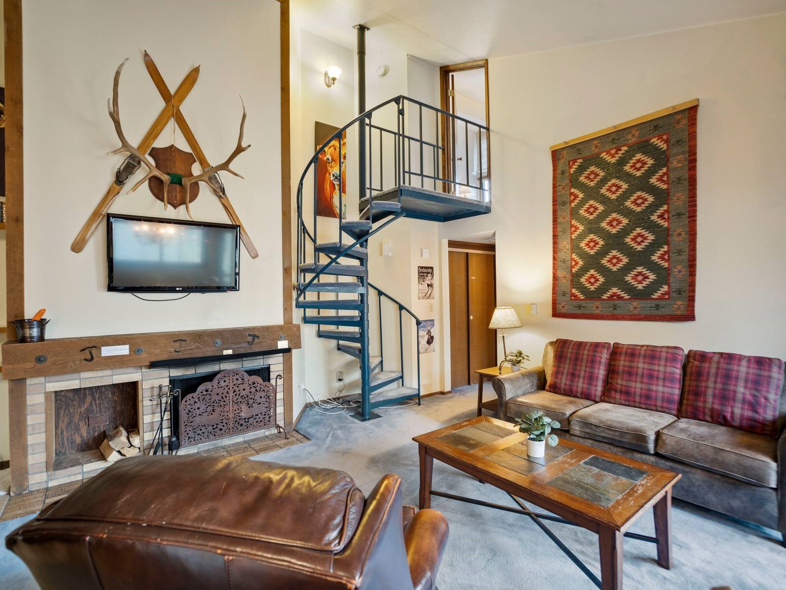 Carpeted living room featuring a high ceiling and a fireplace