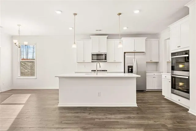 a kitchen with stainless steel appliances a sink stove and refrigerator