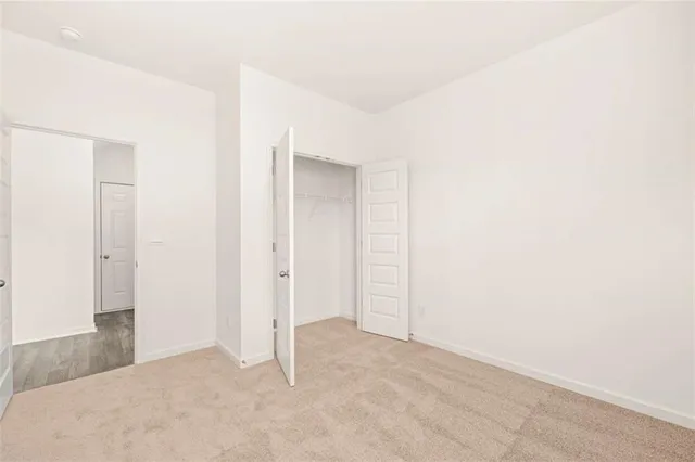 a spacious bathroom with a granite countertop sink a mirror and a shower