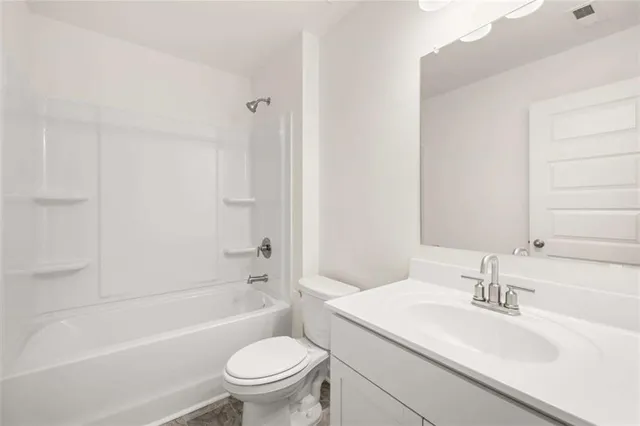 an aerial view of a swimming pool with outdoor seating and yard