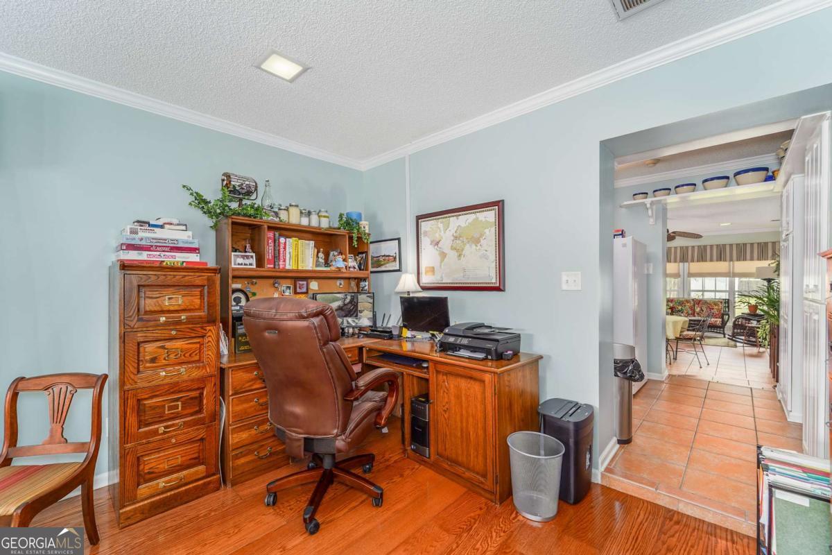 1238 Red Keen Road Waycross, GA 31503 - Photo 15 of 37 a view of a workspace with furniture and a window