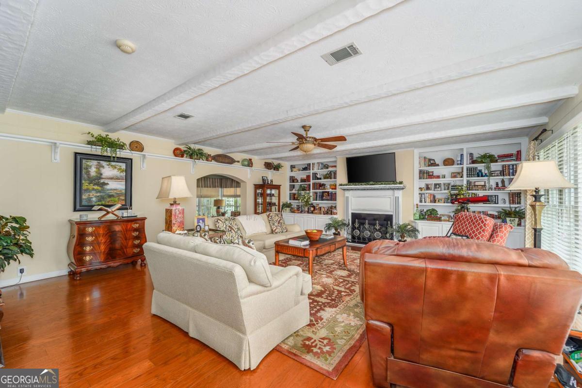 1238 Red Keen Road Waycross, GA 31503 - Photo 20 of 37 a living room with fireplace furniture and a flat screen tv