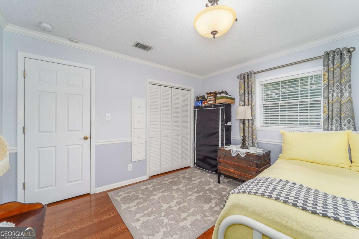 1238 Red Keen Road Waycross, GA 31503 - Photo 25 of 37 a bedroom with a bed and a dresser