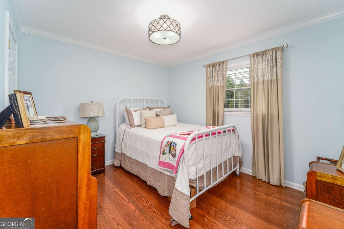 1238 Red Keen Road Waycross, GA 31503 - Photo 27 of 37 a bedroom with a bed and window