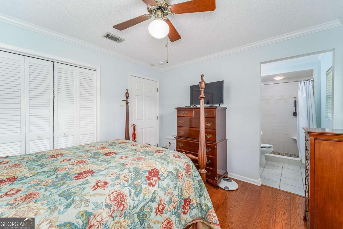 1238 Red Keen Road Waycross, GA 31503 - Photo 29 of 37 a bedroom with a bed and a chandelier