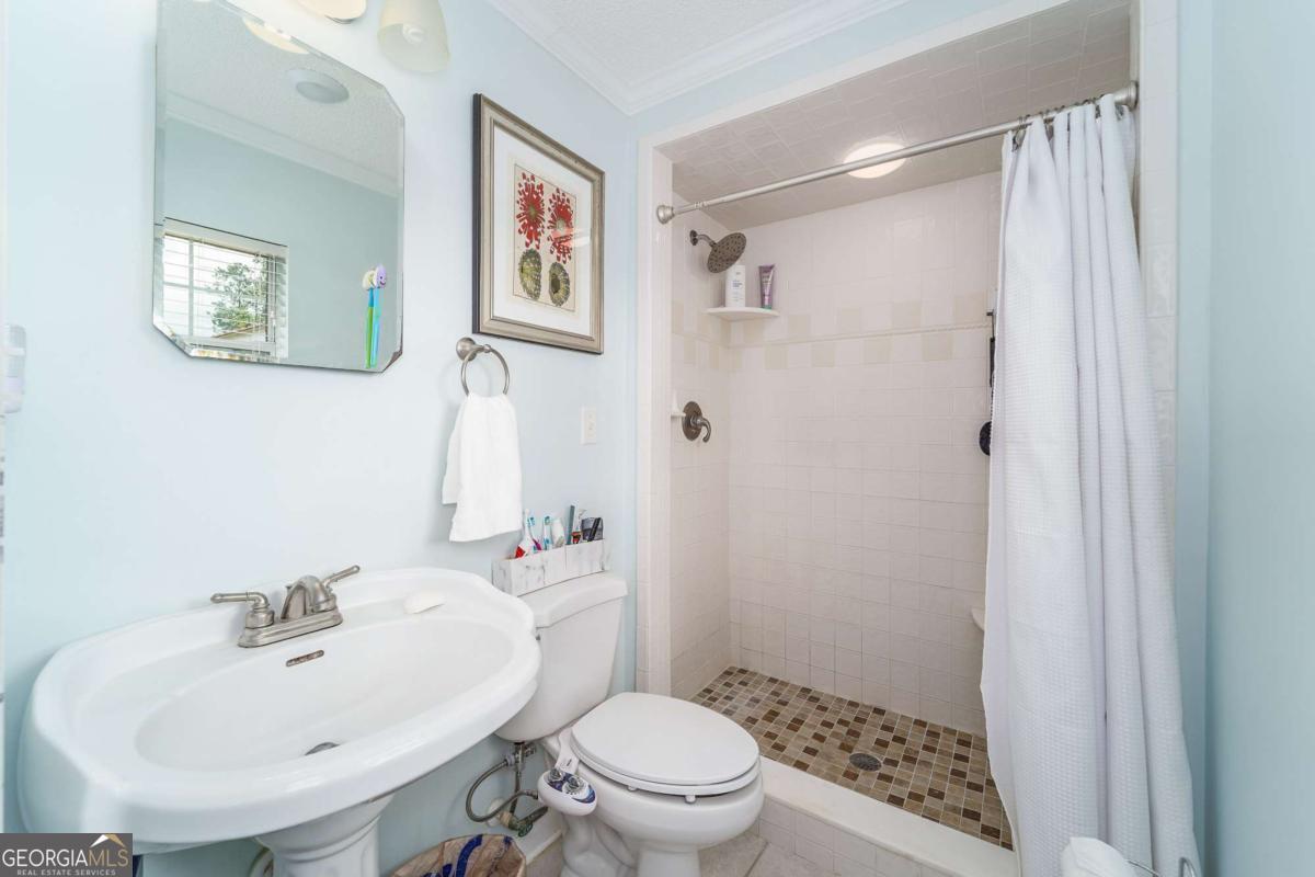 1238 Red Keen Road Waycross, GA 31503 - Photo 30 of 37 a bathroom with a sink toilet and shower
