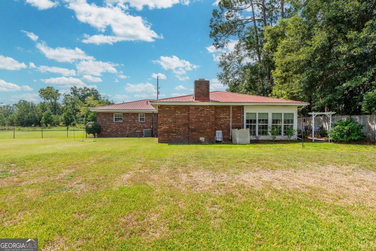 1238 Red Keen Road Waycross, GA 31503 - Photo 34 of 37 a front view of a house with a big yard