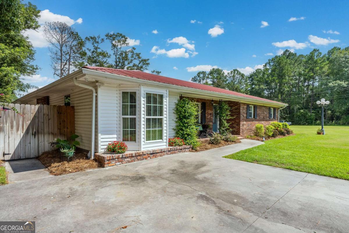 1238 Red Keen Road Waycross, GA 31503 - Photo 35 of 37 a front view of a house with a yard and porch