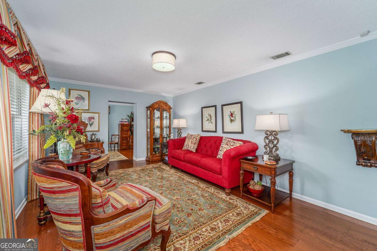 1238 Red Keen Road Waycross, GA 31503 - Photo 5 of 37 a living room with furniture a couch and a potted plant
