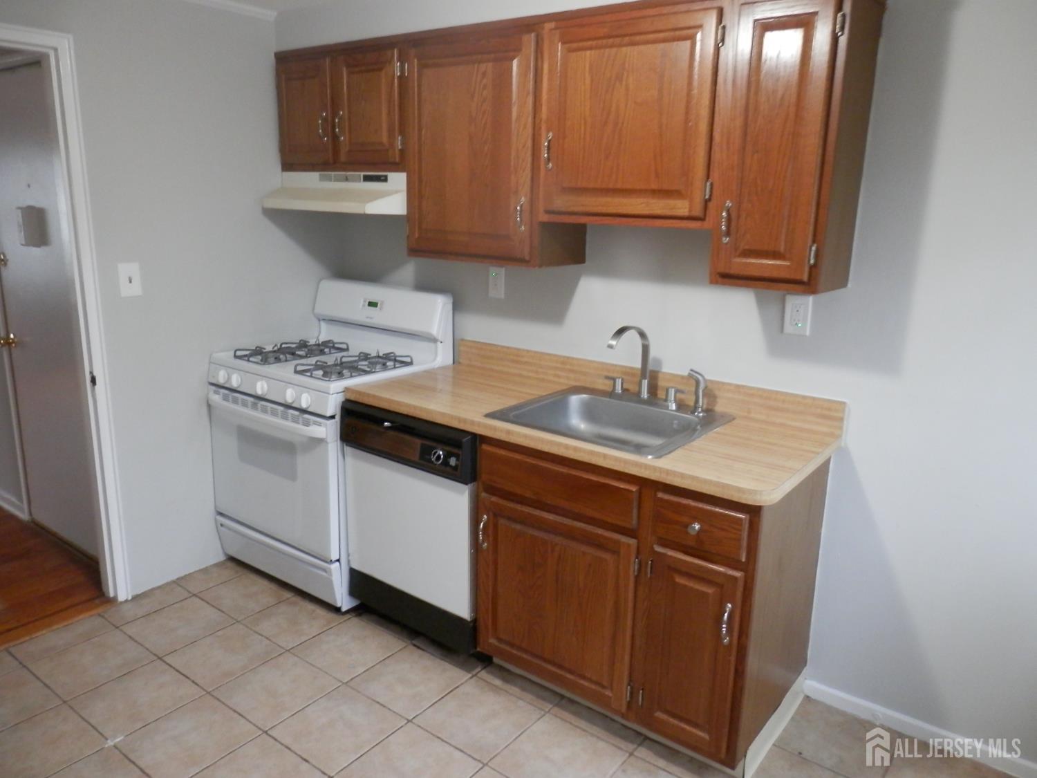39A Garfield Park, Unit B Edison, NJ 08837 - Photo 11 of 11 a kitchen with a sink stove and cabinets