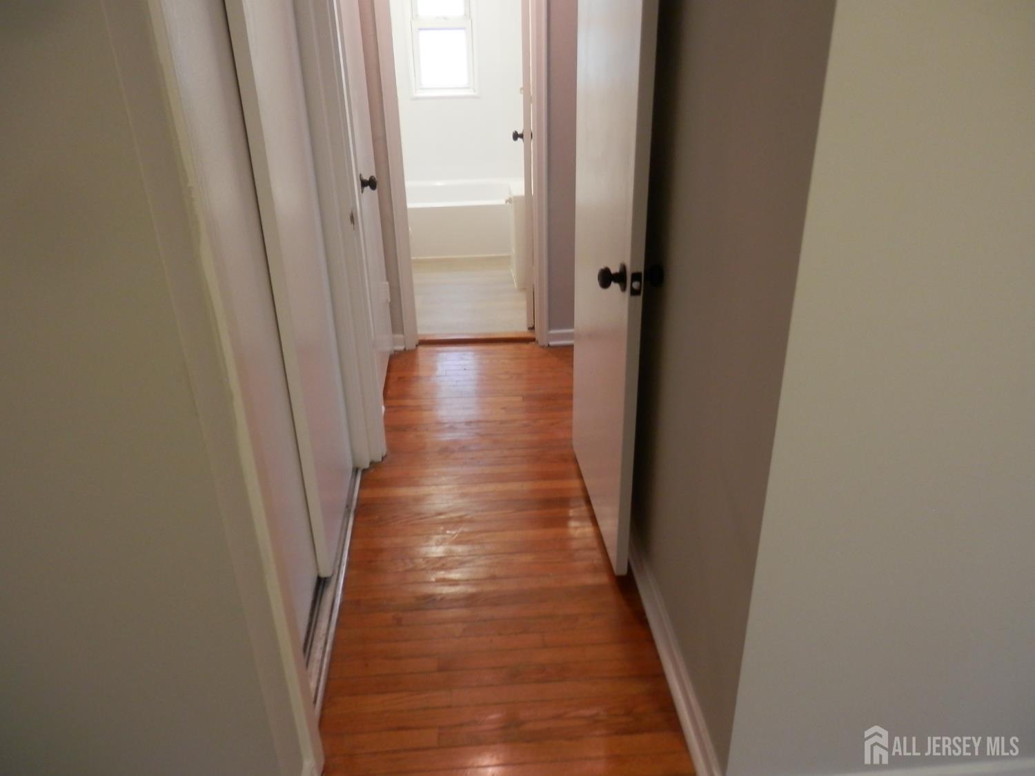 39A Garfield Park, Unit B Edison, NJ 08837 - Photo 4 of 11 a view of a hallway with wooden floor and staircase