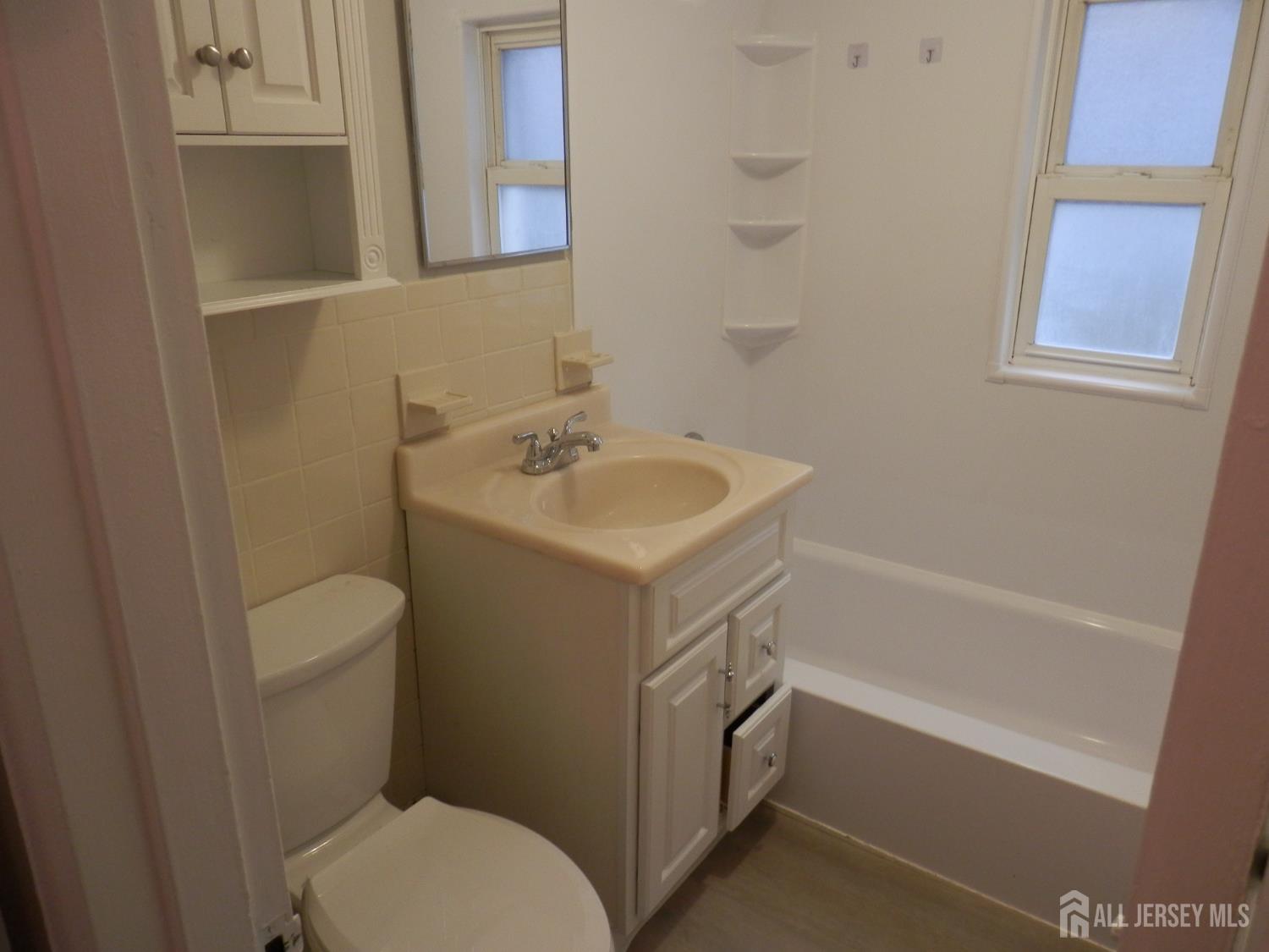 39A Garfield Park, Unit B Edison, NJ 08837 - Photo 5 of 11 a bathroom with a sink toilet and vanity