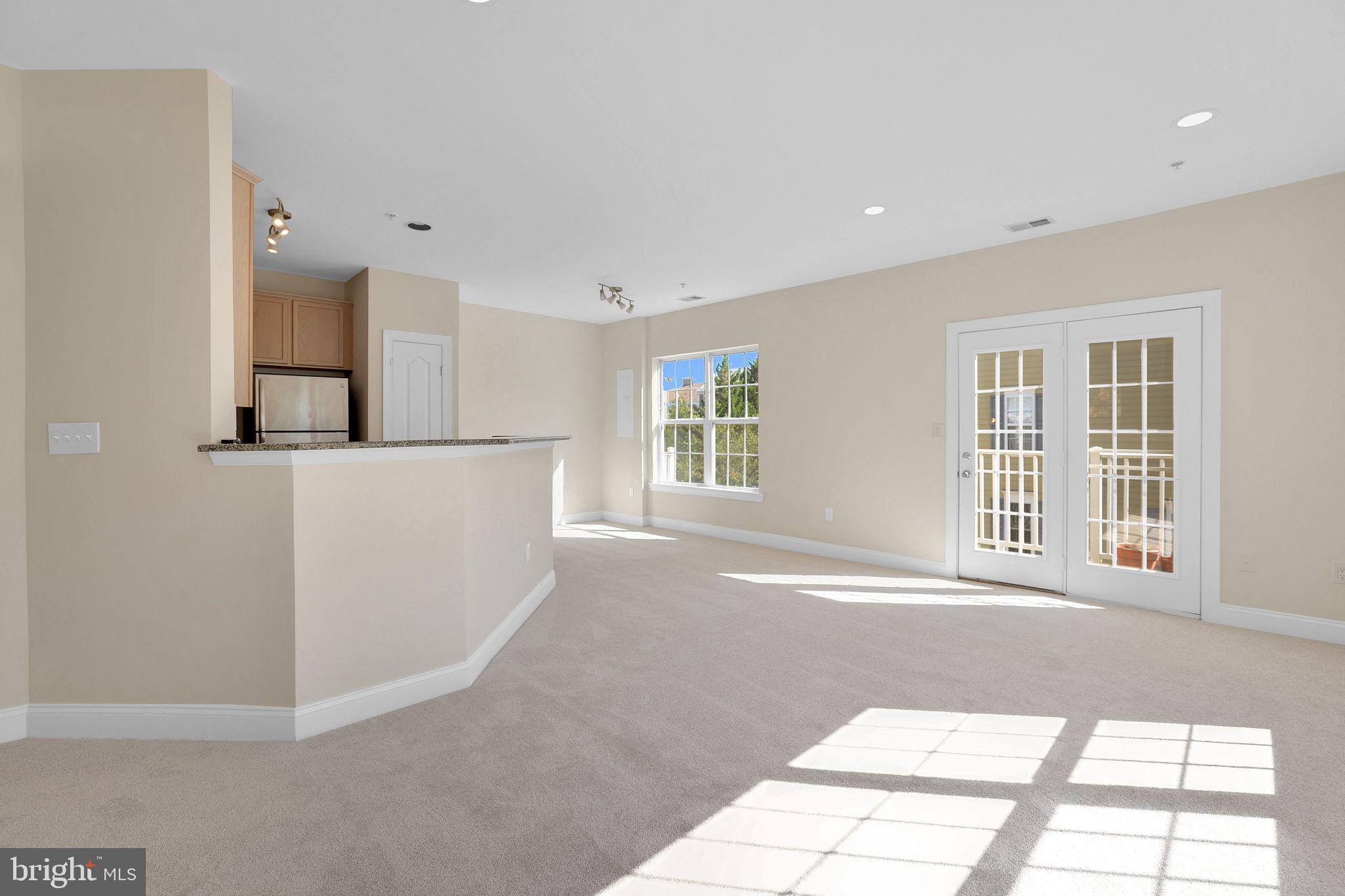 111 A Chevy Chase Street, Unit 111A Gaithersburg, MD 20878 - Photo 13 of 47 a view of a big room with windows and entryway of the house