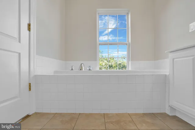 a bathroom with a bathtub and window
