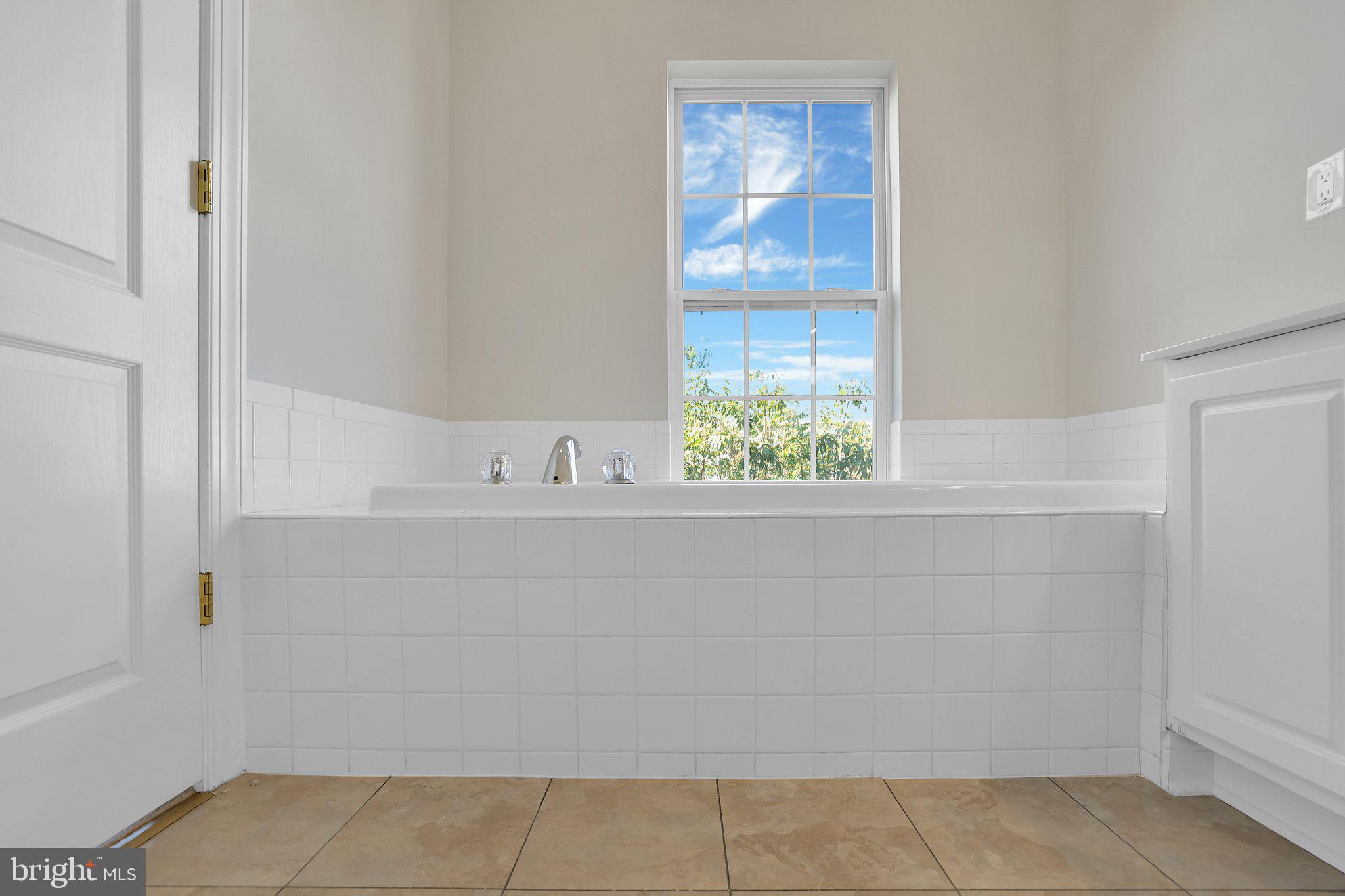 111 A Chevy Chase Street, Unit 111A Gaithersburg, MD 20878 - Photo 23 of 47 a bathroom with a bathtub and window