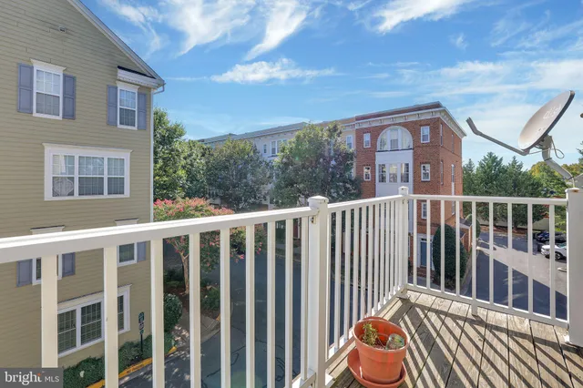 a view of a balcony with wooden floor and fence