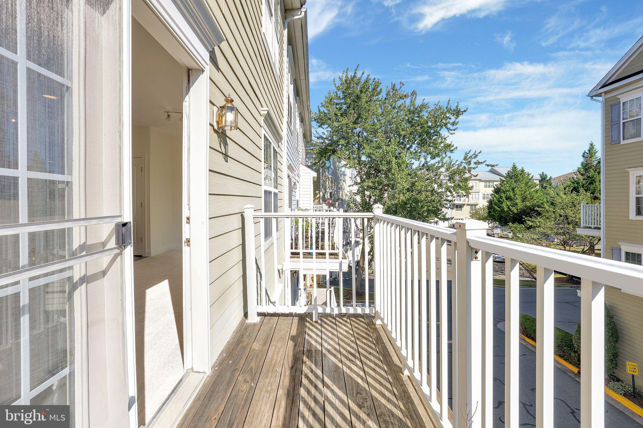 111 A Chevy Chase Street, Unit 111A Gaithersburg, MD 20878 - Photo 36 of 47 a view of a balcony with wooden floor and fence
