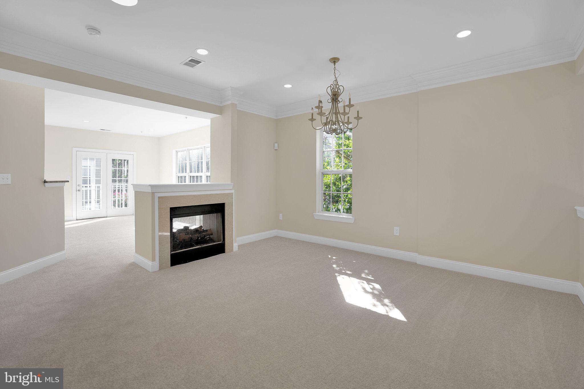 111 A Chevy Chase Street, Unit 111A Gaithersburg, MD 20878 - Photo 4 of 47 an empty room with windows and fireplace