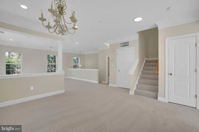 an empty room with windows and fireplace