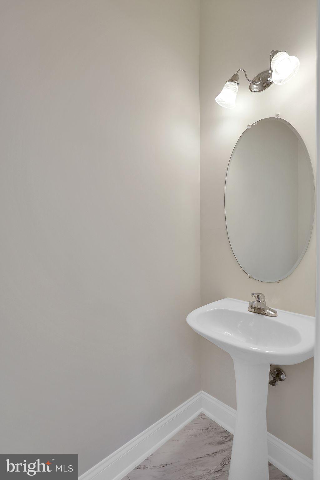 111 A Chevy Chase Street, Unit 111A Gaithersburg, MD 20878 - Photo 7 of 47 a bathroom with a sink and a mirror