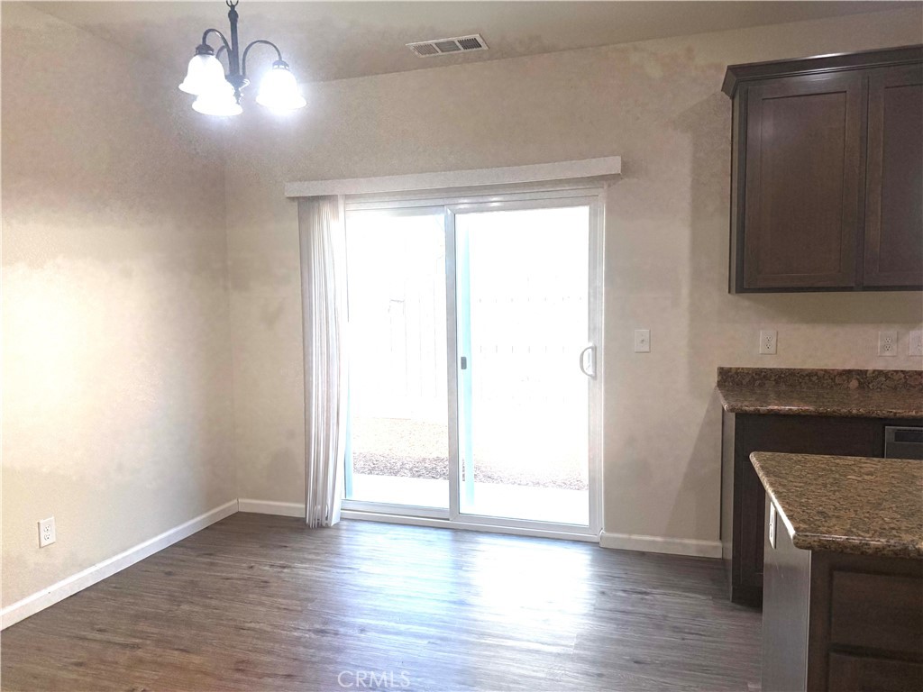 1339 Playa Del Rey Drive Merced, CA 95348 - Photo 11 of 48 a view of empty room with wooden floor and fireplace