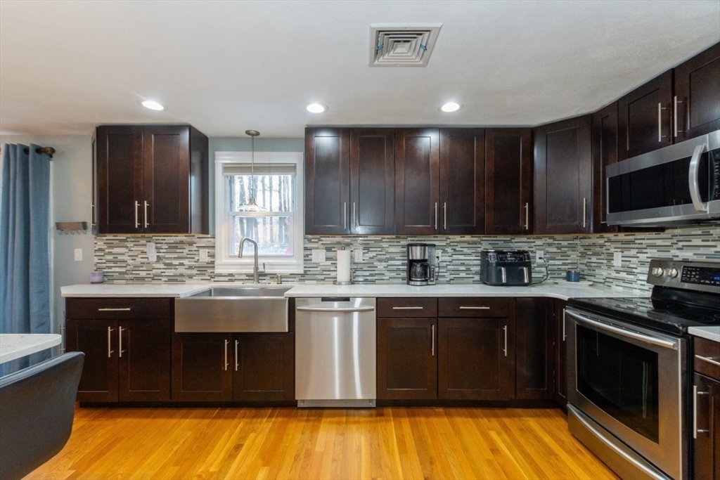 9 Bruce Street Burlington, MA 01803 - Photo 12 of 38 a kitchen with stainless steel appliances granite countertop wooden cabinets counter top space and a sink