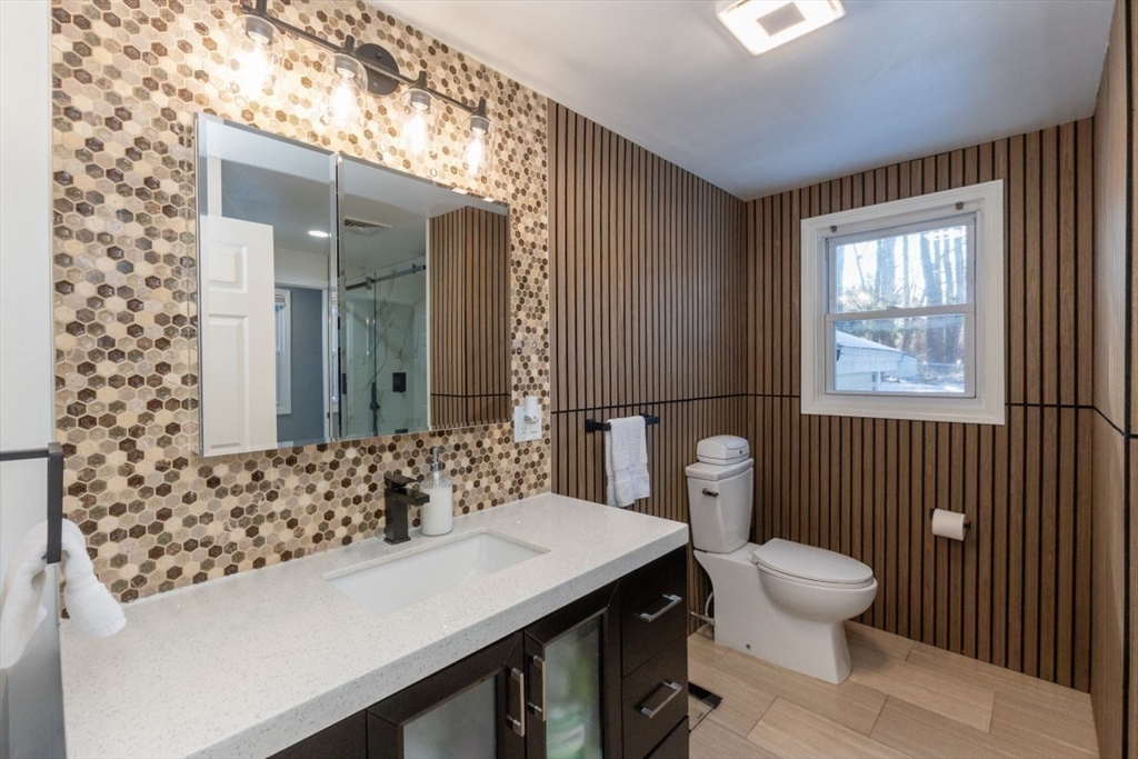 9 Bruce Street Burlington, MA 01803 - Photo 17 of 38 a bathroom with a sink a toilet and shower