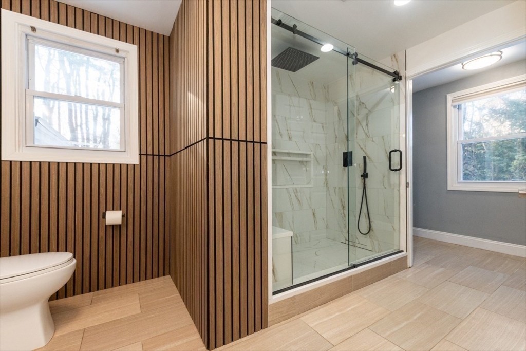 9 Bruce Street Burlington, MA 01803 - Photo 18 of 38 a bathroom with a glass shower door