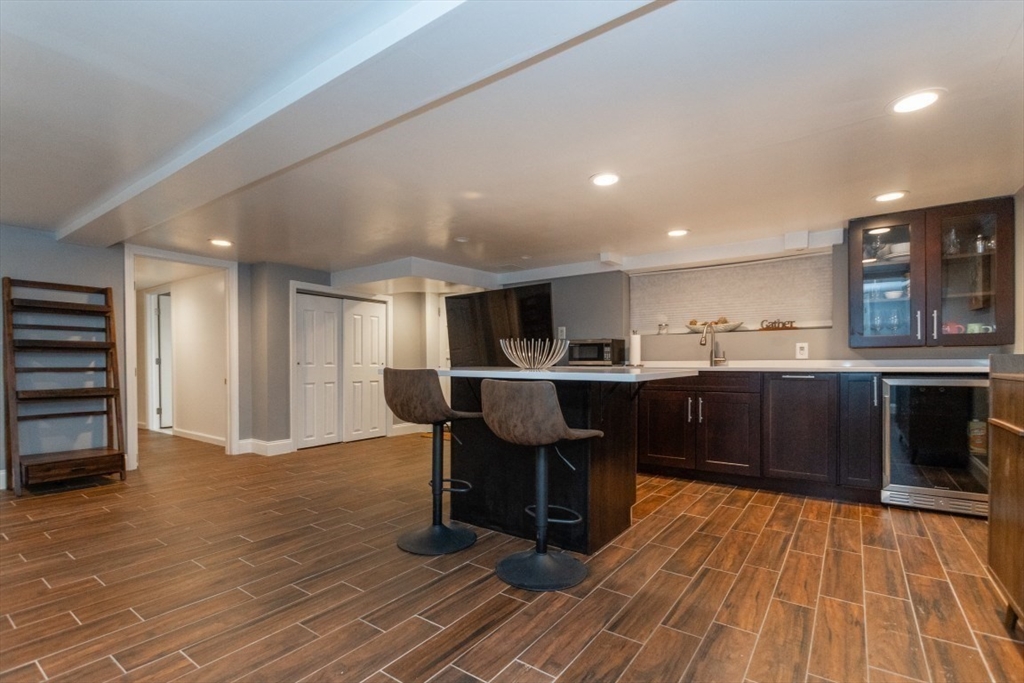 9 Bruce Street Burlington, MA 01803 - Photo 20 of 38 a kitchen with stainless steel appliances kitchen island granite countertop a table chairs sink and cabinets