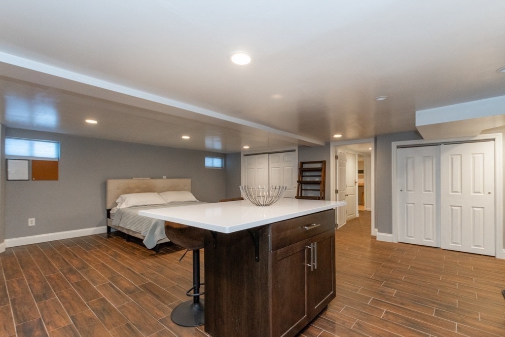 9 Bruce Street Burlington, MA 01803 - Photo 21 of 38 a living room with a table chairs and a wooden floor