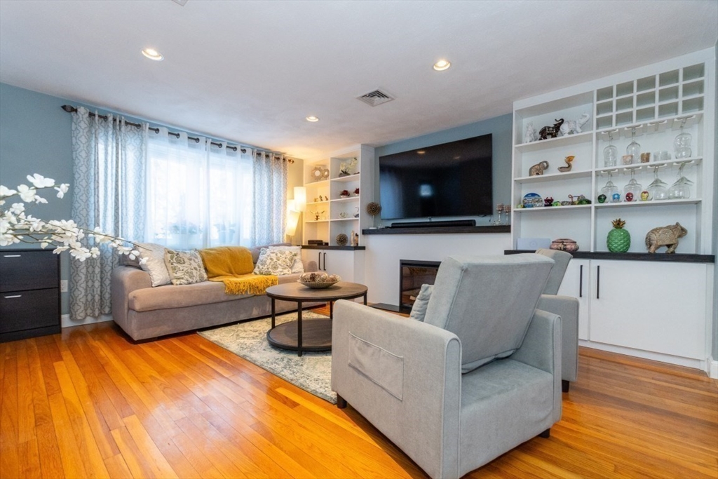 9 Bruce Street Burlington, MA 01803 - Photo 5 of 38 a living room with fireplace furniture and a flat screen tv