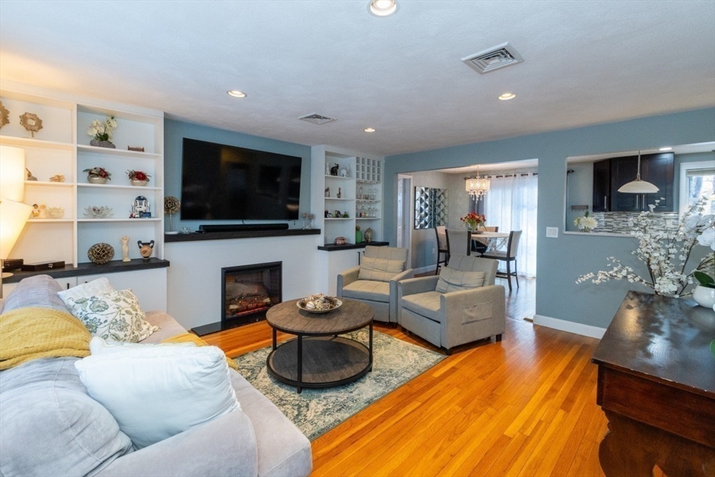 9 Bruce Street Burlington, MA 01803 - Photo 6 of 38 a living room with fireplace furniture and a flat screen tv