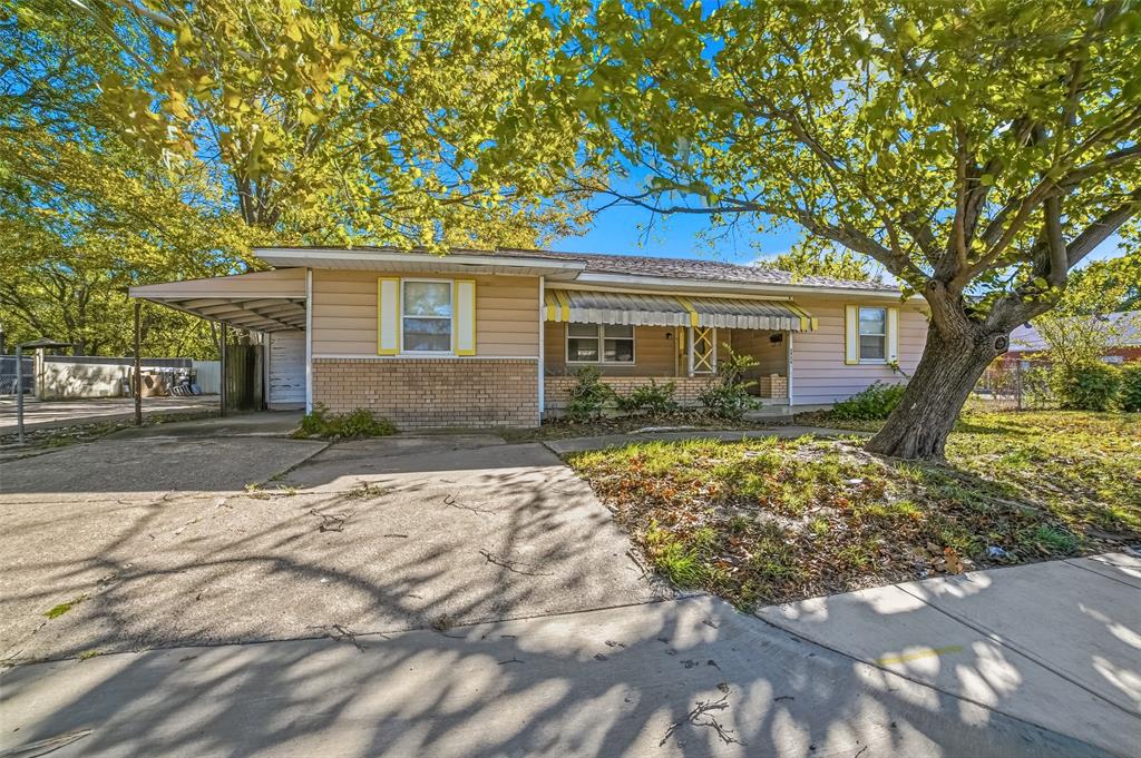 2926 North Prairie Creek Road Dallas, TX 75227 - Photo 1 of 22 a front view of a house with a garden